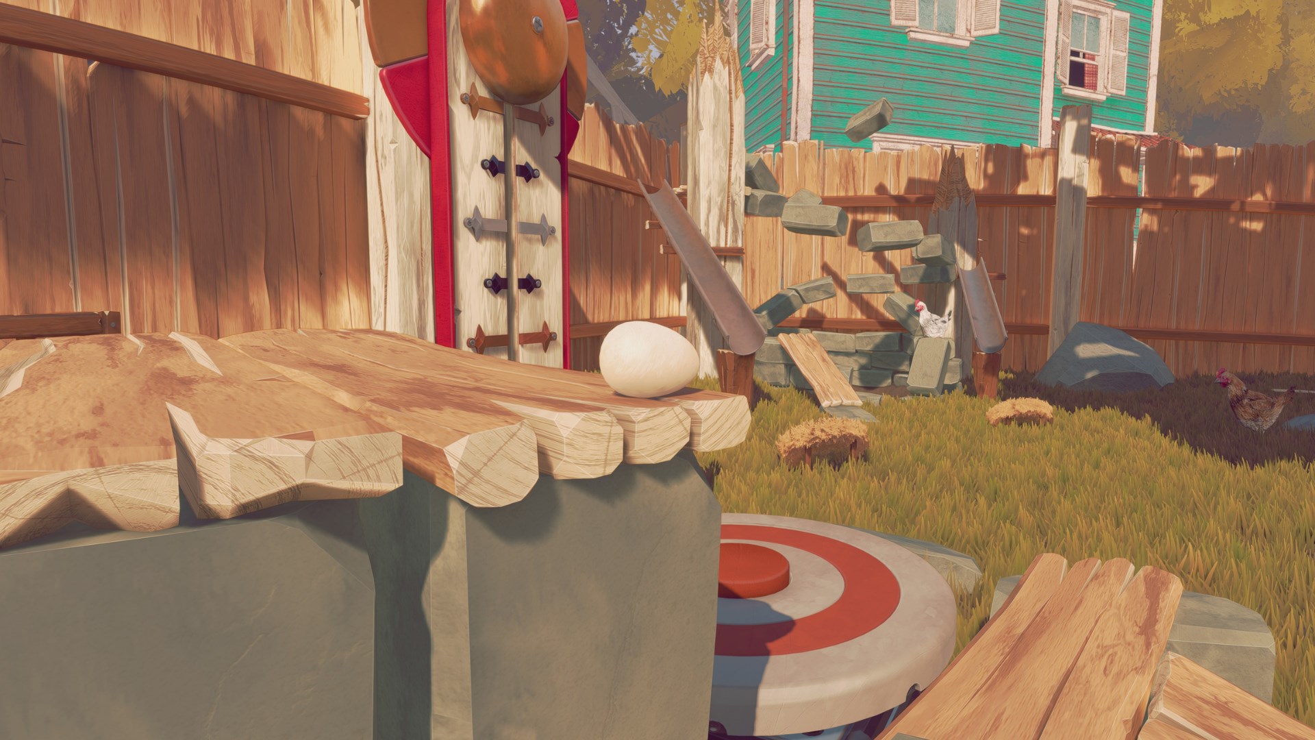 Egg on a ledge next to a funfair hammer game.