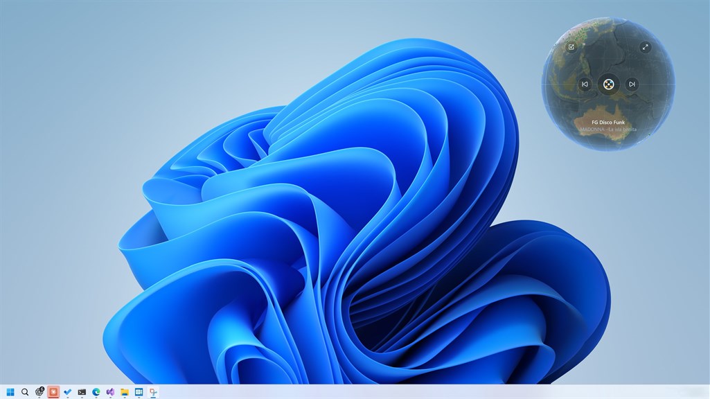 The frameless Radio Gaga globe widget resting in the corner of a Windows 11 desktop