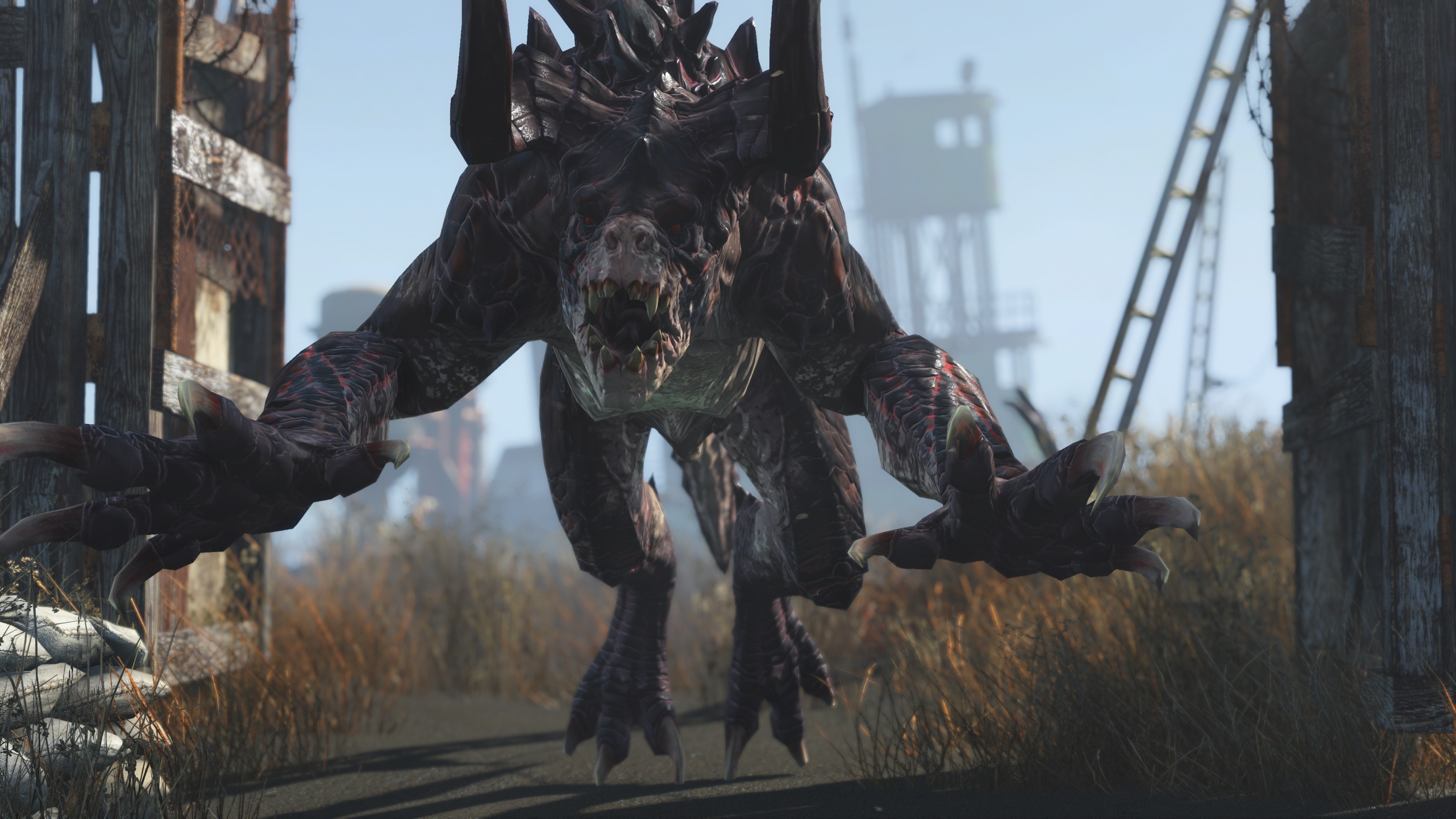 Fallout 4: Anniversary Edition - A snarling Deathclaw lunges forward, claws outstretched, in a desolate wasteland.